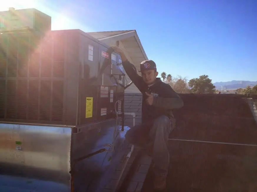 HVAC technician performing HVAC Inspection on a rooftop unit in Fair Oaks